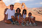 Windblown family reaches Delicate Arch