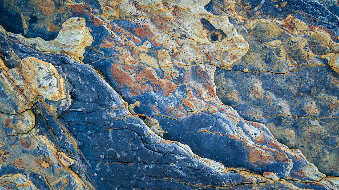 The rocks come alive on Weston Beach at sunset